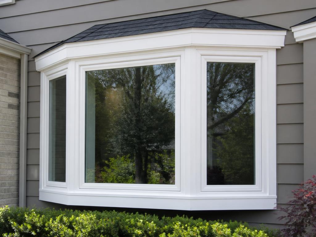 White vinyl bay window installed on the front of a home with new exterior trim